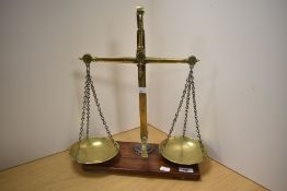 A set of Victorian brass class B beam scales, of traditional arrangement with oblong mahogany