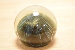 A John Ditchfield art glass paperweight, of spherical form with integral iridescent swirl design,