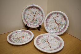 Four oriental plates having florescent wildlife design to centre and gilding to rims.