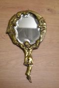 A late 19th/ early 20th Century brass coloured vanity mirror, the detail representing figures