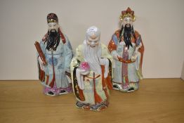 A group of three 20th century Chinese pottery immortals, each decorated in polychrome and
