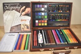 A collection of Art supplies including a box of crayons, paints and a Sheaffer No Nonesense