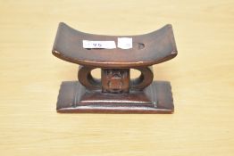 A miniature African carved wood Ashanti stool 8cm x 13cm