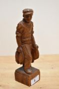 A 20th Century folk art study of a fisherman and his catch, signed 'W.Lang' to the rear and