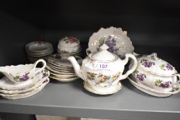 A vintage miniature tea set having violla's to white porcelain sold alongside other miniature