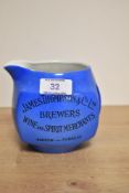 An early 20th Century James Green & Nephew whisky water jug, enamelled in blue with black lettering,
