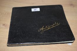 An early 20th Century autograph album containing poetry and caricature illustrations