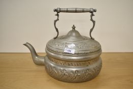 A Turkish embossed white metal flat-bottomed kettle, of traditional design with bands of embossed