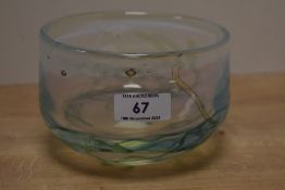 A John Ditchfield vaseline glass bowl, tinted in green and blue with a trailed design, etched and
