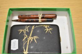 A Conway Stewart 526 Dinkie lever fill fountain pen and Dura point propelling pencil in red and