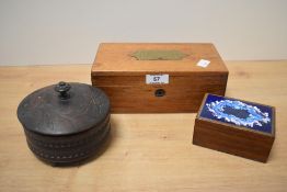 An Indian lidded wooden box, of circular form with foliate and poker work design, measuring 11cm