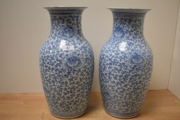 A pair of 19th Century Chinese blue and white vases, of baluster form and decorated floral sprays