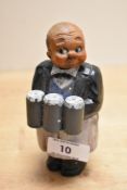 An early 20th Century painted Folk Art novelty corkscrew and holder, in the form of a butler and