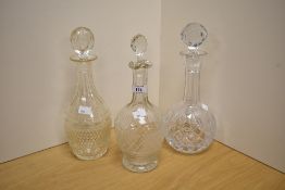 Three cut glass decanters.