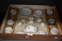 A Continental porcelain miniature tea service, decorated with floral sprays and heightened with