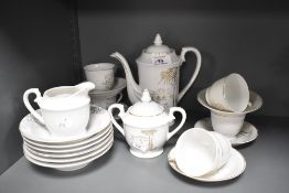 A vintage Japanese coffee set having gilted bamboo designs to white porcelain, comprising twenty