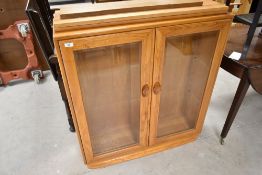 A modern Ercol bookcase, approx. Width 91cm