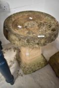 A concrete bird bath on stand