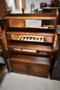 A 19t Century Arts & Crafts mahogan waterfall bookshelf with double cupboard under, approx 76 x