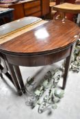 A 19th Century mahogany demi lune fold over tea table, width approx. 90cm