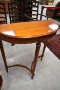 A reproduction half moon hall table