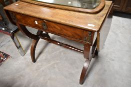 A 19th Century walnut side table having applique decoration, drop flaps to ends , frieze drawers and