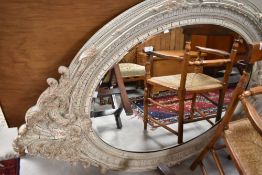 A reproduction oversized mirror having crackle effect foliate surround, approx. 150 x 104cm
