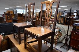 Two Georgian oak solid seat dining chairs