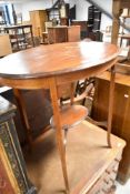 An Edwardian mahogany occasional table of oval form