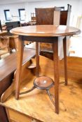 An Edwardian mahogany occasional table having circular top and undertier on square splay legs,