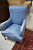 An early 20th Century low seat easy chair