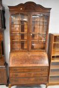 An early to mid 20th Century walnut bureau bookcase