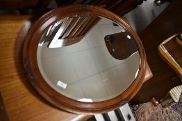 An early 20th Century mahogany oval wall mirror, approx. 83 x 57cm