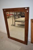A modern stained pine wall mirror, approx. 108 x 78cm