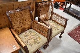 A pair of bergere armchairs in need of restoration