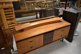 A vintage teak effect dressing table, approx width 145cm