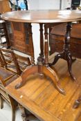 A 19th Century mahogany occasional table having oval top, triple turned supports and splay legs,