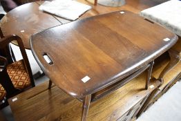 A vintage dark stained Ercol tray style coffee table