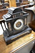 A Victorian black slate mantel clock