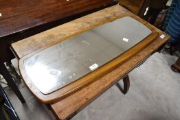 A vintage teak effect mounted wall mirror, approx. 67 x 29cm