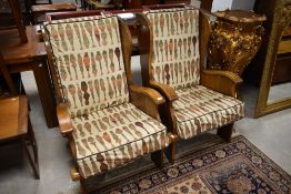 A pair of Arts and Crafts style craftsman lambing style easy chairs, labelled Glenster, similar to