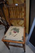 A Victorian spindle back bedroom chair having later upholstered seat