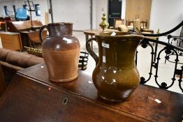 A pair of period earthernware jugs, including glazed