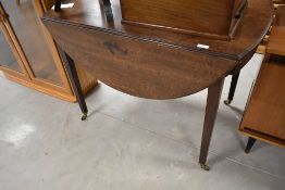 A 19th Century mahogany breakfast table in the Pembroke style, having frieze drawer and square