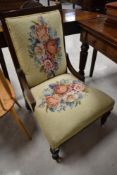 A Victorian mahogany framed nursing chair with tapestry back and seat