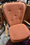 An Ercol easy chair and three carvers, two having fleur de lys pattern