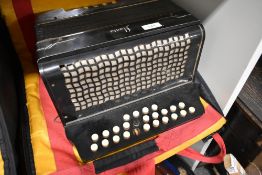 A vintage Schlossinetrel button accordion , sold with later accordion case (German)