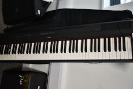 A Yamaha digital piano - P115, with manual, power supply and padded gig bag, sold with fault, bottom