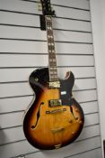 A Vintage VSA-575-TS hollow body archtop electric guitar