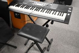 An Alesis Harmony 61 electronic keyboard, with stand and stool